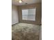 Bedroom featuring neutral walls, plush carpet, and natural light from a large window at 3305 Wickum Sw Rd, Atlanta, GA 30349