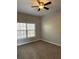 Cozy bedroom with carpet flooring, a ceiling fan, neutral-colored walls, and a bright window at 3305 Wickum Sw Rd, Atlanta, GA 30349