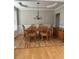 Elegant dining room with hardwood floors, tray ceiling, and classic chandelier, ideal for formal gatherings at 3305 Wickum Sw Rd, Atlanta, GA 30349