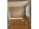 Bright living room featuring hardwood floors, crown molding, and a large window offering ample natural light at 3305 Wickum Sw Rd, Atlanta, GA 30349