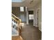 Open-concept living room with fireplace, neutral carpet and paint, large windows, and staircase at 3305 Wickum Sw Rd, Atlanta, GA 30349