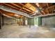 Spacious unfinished basement with concrete walls, exposed ductwork, and stairs at 664 Church Nw St, Atlanta, GA 30318