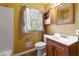 Bathroom with vanity, toilet, wall cabinet and shower with window at 664 Church Nw St, Atlanta, GA 30318