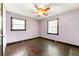 Quaint bedroom with ceiling fan, hardwood floors, and natural light from two windows at 664 Church Nw St, Atlanta, GA 30318