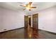 Bedroom featuring hardwood floors, ceiling fan, and multiple closets and doorways at 664 Church Nw St, Atlanta, GA 30318