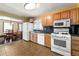 Well-equipped kitchen with adjacent dining area, white appliances, and wood cabinets at 664 Church Nw St, Atlanta, GA 30318