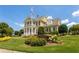 Exterior view of community clubhouse with manicured landscaping, lush lawn, and flagpole at 224 Village Overlook # K3, Canton, GA 30114