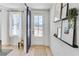 Bright entryway with hardwood floors, barn door, decorative shelves, and a view to the outside at 224 Village Overlook # K3, Canton, GA 30114