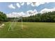 Open green community field with a soccer goal and walking path at 224 Village Overlook # K3, Canton, GA 30114