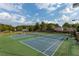 Community tennis courts on a sunny day with professional surfaces and mature trees at 224 Village Overlook # K3, Canton, GA 30114