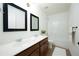 Well-lit bathroom with double sinks, a shower and a tub at 5750 Palmtree Pass, Cumming, GA 30040