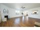 Light-filled living area with hardwood floors, fireplace, and seamless flow to kitchen at 5750 Palmtree Pass, Cumming, GA 30040