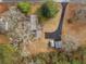 Birds eye view of the home, driveway, storage sheds and backyard featuring mature trees at 583 Mount Zion Rd, Oxford, GA 30054
