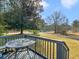 Wooden deck with a metal table and chairs offering scenic views of the outdoor landscape at 583 Mount Zion Rd, Oxford, GA 30054