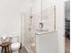 Bright bathroom featuring a toilet and a large shower with glass enclosure and white subway tile at 583 Mount Zion Rd, Oxford, GA 30054
