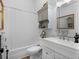 Bright bathroom featuring a shower/tub combo, single vanity with white cabinetry, and mirrored medicine cabinet at 583 Mount Zion Rd, Oxford, GA 30054