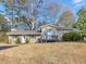 Well-maintained home with a inviting front porch, established trees, and a manicured lawn at 583 Mount Zion Rd, Oxford, GA 30054