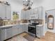 A kitchen featuring light gray cabinetry, stainless steel appliances, and hardwood floors at 583 Mount Zion Rd, Oxford, GA 30054