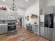 A kitchen featuring stainless steel appliances, white cabinets, and hardwood floors at 583 Mount Zion Rd, Oxford, GA 30054