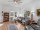 A bright living room featuring a ceiling fan, hardwood floors, and decor at 583 Mount Zion Rd, Oxford, GA 30054