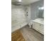 The bathroom features white-tiled walk-in shower, light grey wood-look flooring, and marble vanity at 814 Humphries Sw St, Atlanta, GA 30310