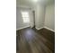 Bright bedroom with a window and modern flooring, freshly painted in neutral tones at 814 Humphries Sw St, Atlanta, GA 30310