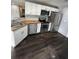 Bright kitchen with white cabinets, butcher block countertops, and stainless steel appliances at 814 Humphries Sw St, Atlanta, GA 30310