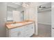 Bright bathroom featuring double sink vanity and view into adjacent bedroom at 106 Saint Margrit Cir, Stockbridge, GA 30281