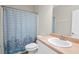 Neutral toned bathroom featuring single sink vanity with blue shower curtain at 106 Saint Margrit Cir, Stockbridge, GA 30281