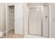 Bathroom featuring a large walk-in closet with shelving and glass shower at 106 Saint Margrit Cir, Stockbridge, GA 30281