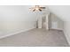 Bedroom with ceiling fan, carpet, and an open door at 106 Saint Margrit Cir, Stockbridge, GA 30281