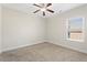 Spacious bedroom featuring plush carpet, ceiling fan and a window at 106 Saint Margrit Cir, Stockbridge, GA 30281