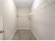 Empty walk-in closet with wire shelving and carpet flooring at 106 Saint Margrit Cir, Stockbridge, GA 30281