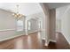 Dining room with modern chandelier, open archway, and hardwood floors at 106 Saint Margrit Cir, Stockbridge, GA 30281