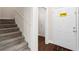 Entryway with carpeted stairs, a secured front door, and views to a hallway at 106 Saint Margrit Cir, Stockbridge, GA 30281