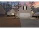 Charming single-story brick home with a two-car garage and well-maintained lawn at twilight at 106 Saint Margrit Cir, Stockbridge, GA 30281