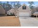 Charming single-story brick home with a two-car garage and well-maintained lawn at 106 Saint Margrit Cir, Stockbridge, GA 30281