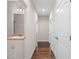 A hallway with hardwood flooring leads to the bathroom, with a sink and vanity at 106 Saint Margrit Cir, Stockbridge, GA 30281