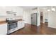 Kitchen with stainless steel appliances, wooden floors, and white cabinets at 106 Saint Margrit Cir, Stockbridge, GA 30281