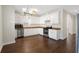 Spacious kitchen with white cabinets, stainless steel appliances, and hardwood flooring at 106 Saint Margrit Cir, Stockbridge, GA 30281