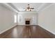 Spacious living room with a brick fireplace, a ceiling fan, and hardwood floors at 106 Saint Margrit Cir, Stockbridge, GA 30281