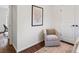 Bedroom with decorative chair and soft rug on hardwood floors at 1887 Cambria Nw Ave, Atlanta, GA 30318