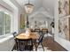 Bright dining room with a modern chandelier, wood floors, and windows overlooking the backyard at 1887 Cambria Nw Ave, Atlanta, GA 30318