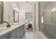 Bathroom featuring double vanity, quartz countertop, walk-in shower and neutral paint at 2380 Edgar Park Pl # 101, Duluth, GA 30096