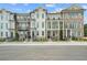 Attractive townhome exteriors featuring brick and siding accents, columns, and manicured landscaping at 2380 Edgar Park Pl # 101, Duluth, GA 30096