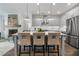 Modern kitchen with stainless steel appliances, gray cabinets, and center island with barstool seating at 2380 Edgar Park Pl # 101, Duluth, GA 30096