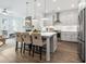 Open-concept kitchen featuring a large island, stainless steel appliances, and modern pendant lighting at 2380 Edgar Park Pl # 101, Duluth, GA 30096