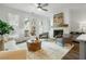 Cozy living room featuring a fireplace, neutral furniture, bright natural light, and wood-look flooring at 2380 Edgar Park Pl # 101, Duluth, GA 30096