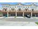 Back of townhomes with garages, wooden decks, and well-manicured lawns at 2380 Edgar Park Pl # 101, Duluth, GA 30096
