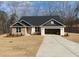 Charming single-story home featuring brick and stone accents, complemented by an attached two car garage at 3382 Milan Ct, Douglasville, GA 30135